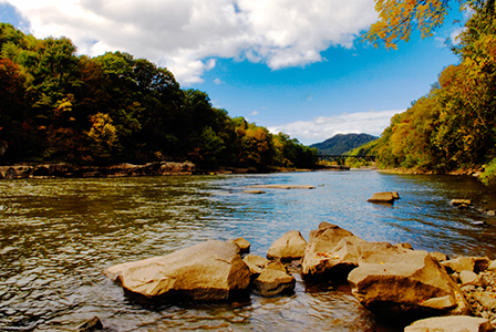 A gently flowing river winds its way lazily through the picturesque mountain valley.